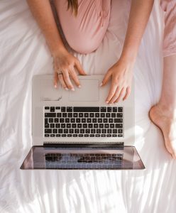 woman sits on the bed during online therapy in VA with nova terra therapy 22015